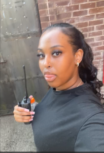 Young woman on film set holding a two way radio