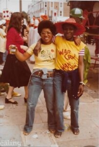 Two women, Dame Elizabeth and Jessica Huntley, stand next to each other, smiling and posing for a photo with their arms around each other.