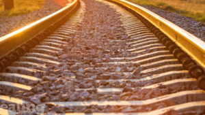 A close-up view of train tracks illuminated by sunlight. HS2 and Ealing Council are in talks to support businesses and residents.