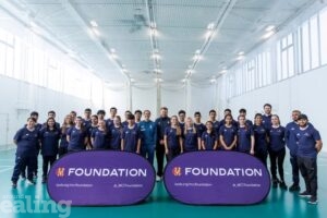 group of young teens standing behind MCC banner
