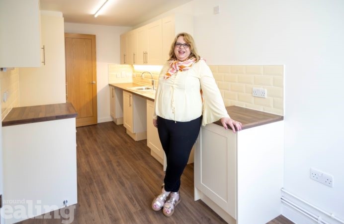 Woman standing in new kitchen in one of the refurbished homes