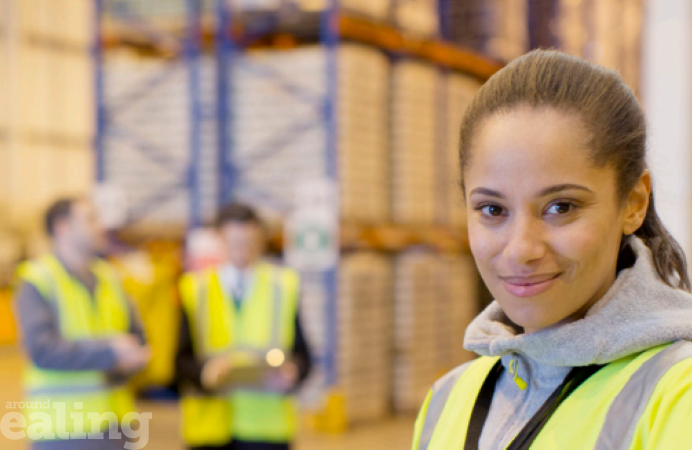 People of different ethnicity in a warehouse wearing high visibility vests