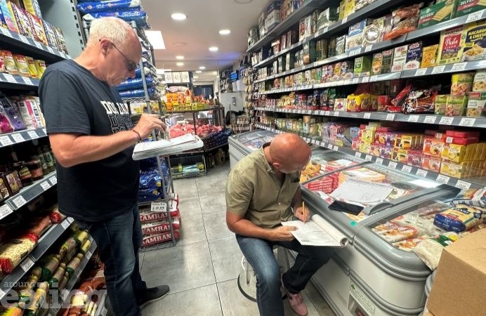Two officers recording under age sale test results in a shop