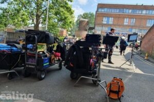 Camera crew and equipment at an outdoor location