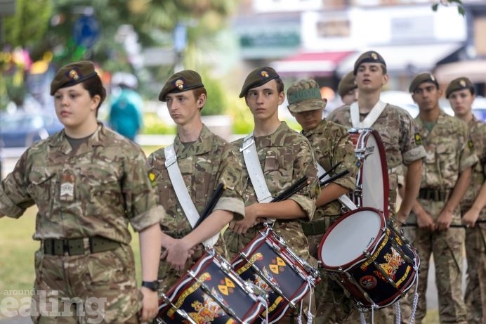 8 cadets in a row with four of them playing drums