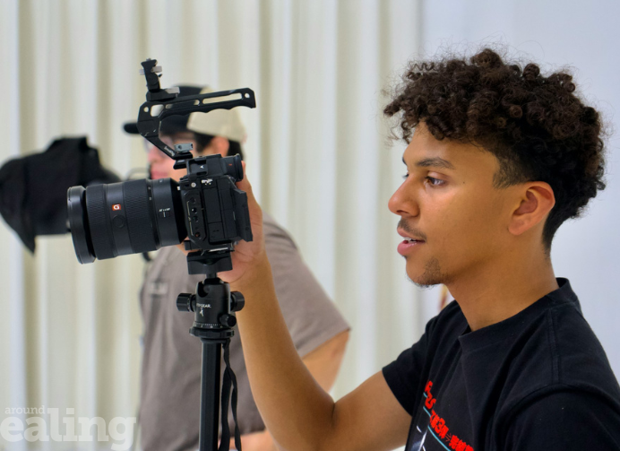 A young person behind the camera
