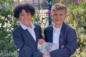 Two children from Stanhope Primary School holding an award