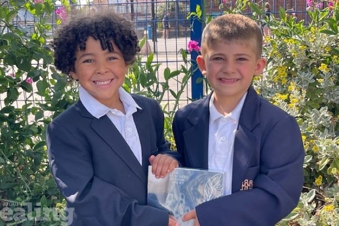 Two children from Stanhope Primary School holding an award