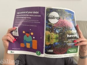 Person holding up a copy of Around Ealing magazine