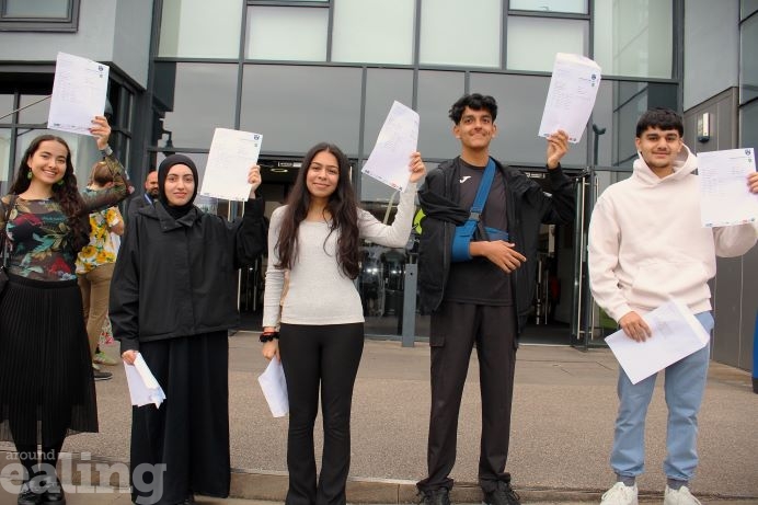 A group of five students holding up their GCSE results in their left hand outside of Featherstone High School