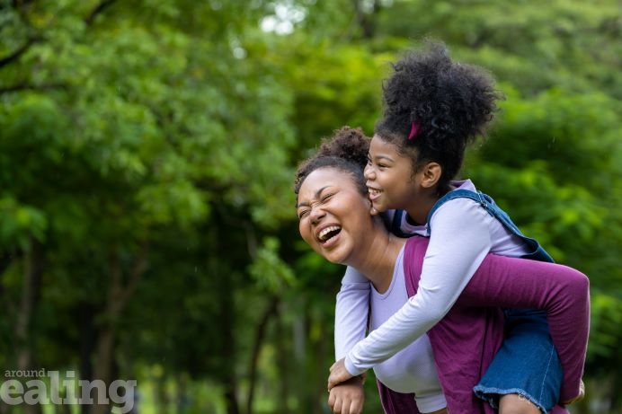 An African American mother and daughter having fun in a forest environment