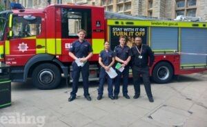 Fire engine with four people standing in front of it