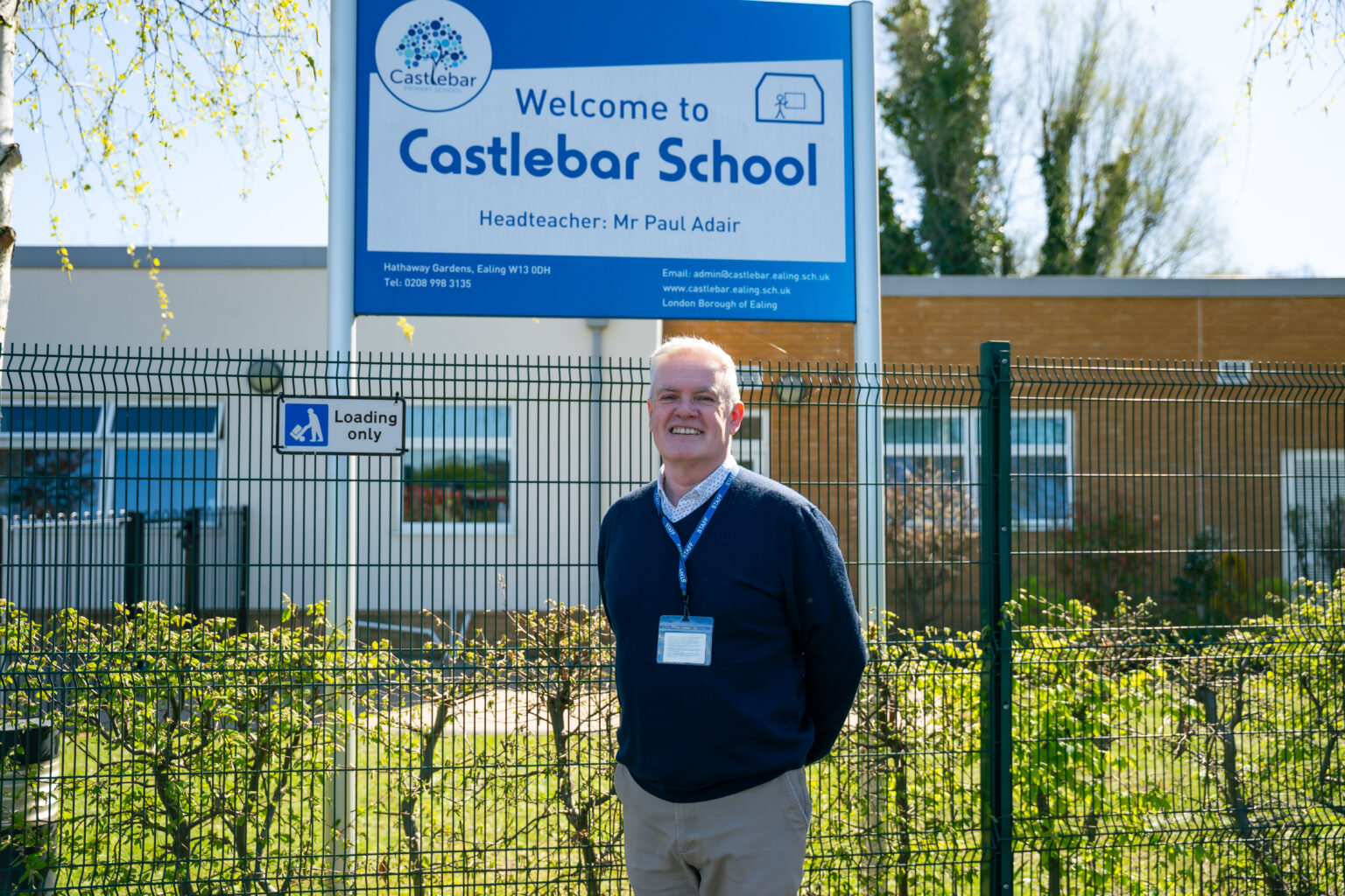 male headteacher outside front of school