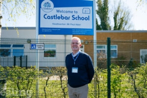male headteacher outside front of school