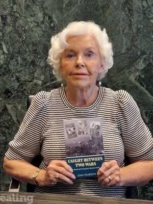 Author Jean Pearson, holding a copy of her book