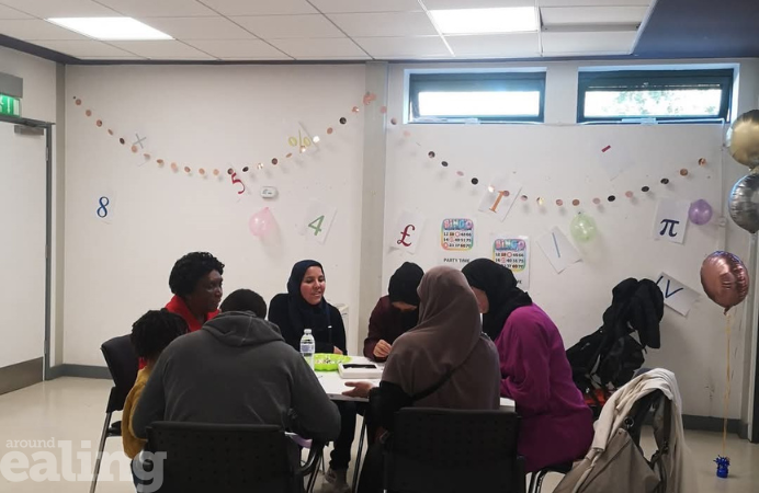 Women and men sitting on a table doing an activity at a previous launch learning zone event