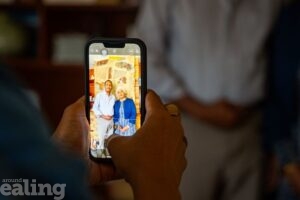 hands holding phone showing photo of foster carers of the year