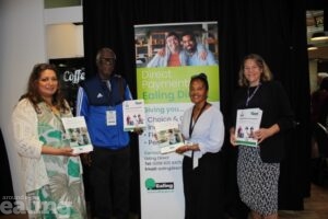Josephine and another service user standing with Councillor Polly Knewstub and council staff, all holding copies of the new direct payment guides