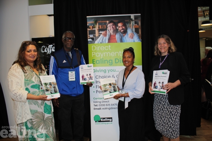 Josephine and another service user standing with Councillor Polly Knewstub and council staff, all holding copies of the new direct payment guides