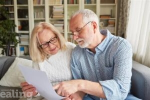 Two pensioners reading a white document