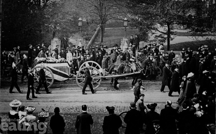Funeral cortege from 1906 with soldiers in uniform walking alongside a coffin draped in the Union Flag and pulled on a cart by horses