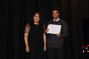 Councillor Nagpal next to Luca, winner of the work experience student of the year. Luca is holding his award certificate. Both are smiling at the camera.