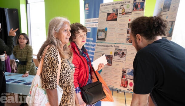 Two women speaking to a man at a Your Voice, Your Town community event.