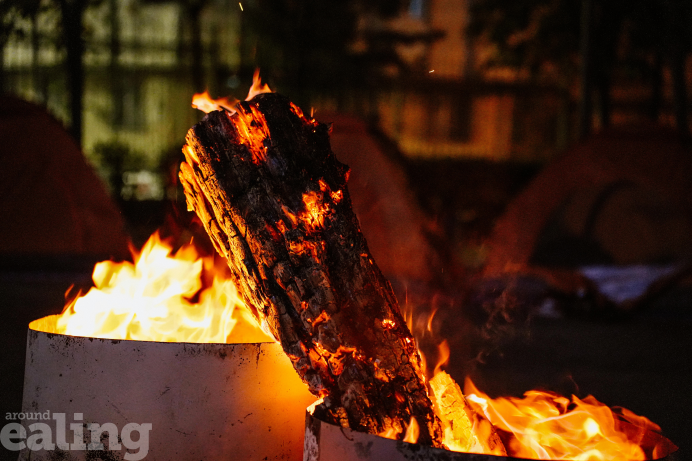 A burning log in a container surrounded by flames