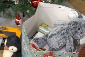 toys in a bag under a Christmas tree
