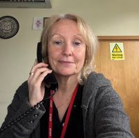 School business manager answering the phone.