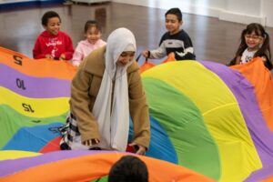 Children play at a HAF event with a carer