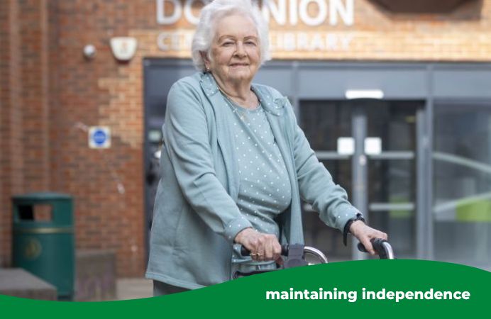 Elderly resident Mary in front of the Dominion Centre with her walker