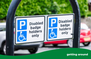 Blue badge holders only sign attached to a metal curved bar