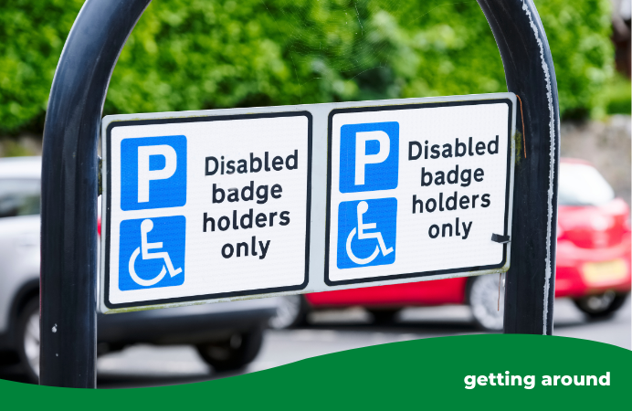 Blue badge holders only sign attached to a metal curved bar