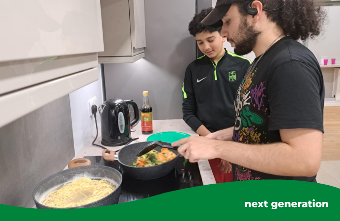 Two young people from the Southall YAC cooking stir fry together