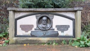 A stone memorial with a metallic sculpted head