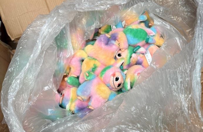 Colourful toys in a plastic bag inside a cardboard box