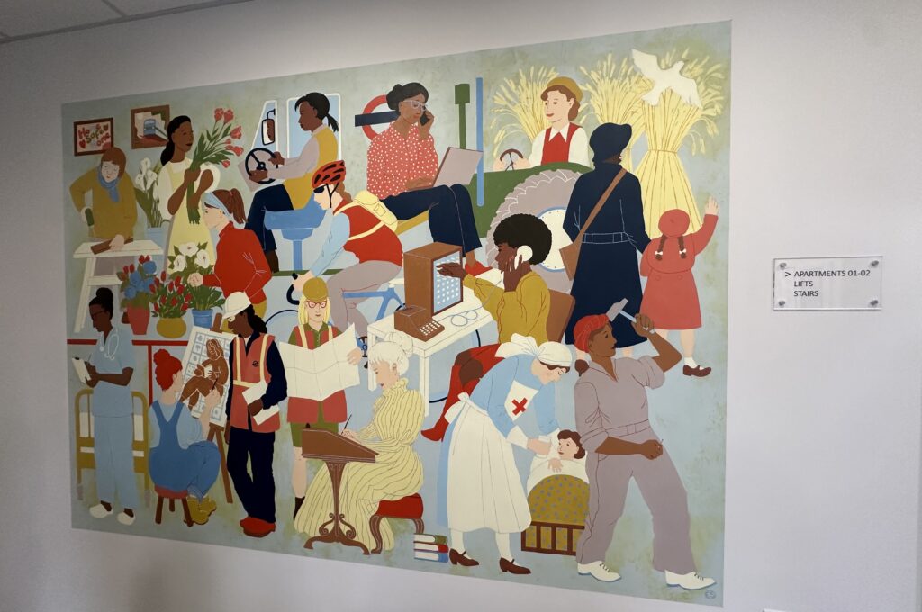 Colourful artwork hanging on a plain white wall