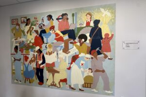 Colourful artwork hanging on a plain white wall