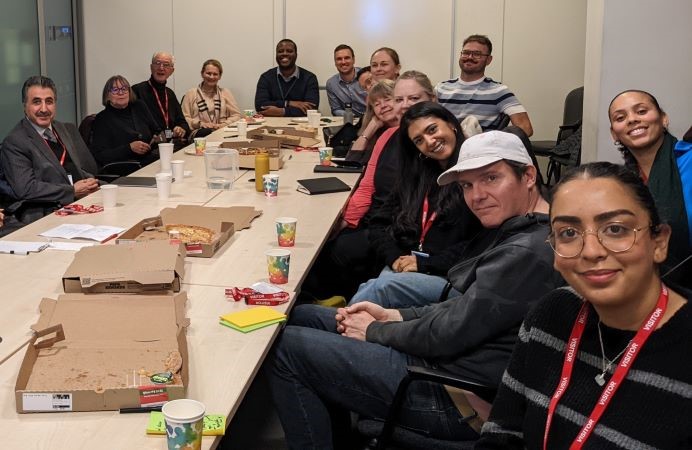 group of people sitting around a table - borough community review panel