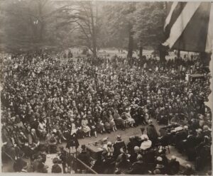 A black and white photo with hundreds of people attending the the official opening of Gunnersbury Park by Neville Chamberlain in May 1926. 