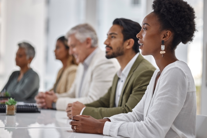 A diverse group of people sat around a table