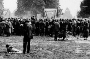 Group of people on an open field gathered for a rally
