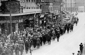Group of people marching down a high street