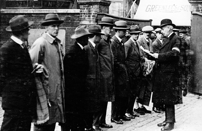 A queue of men wearing hats and suits