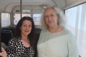 Cllr Lauren Wall Wall and the exhibition's creator, Dr Shabina Aslam, standing on a 'bus'