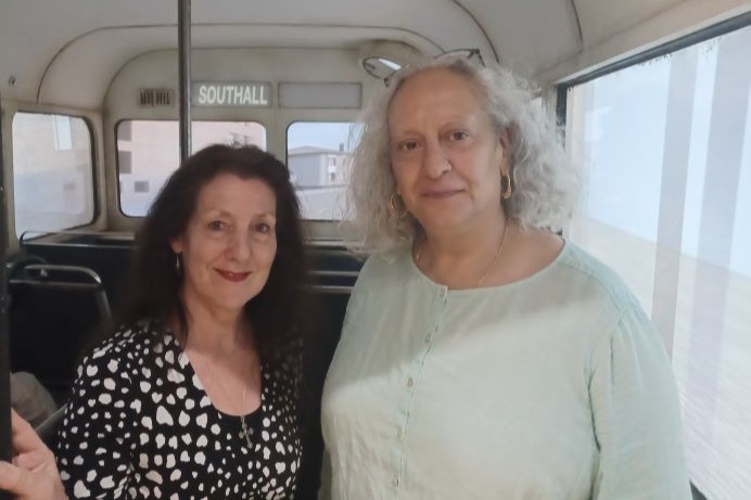Cllr Lauren Wall Wall and the exhibition's creator, Dr Shabina Aslam, standing on a 'bus'