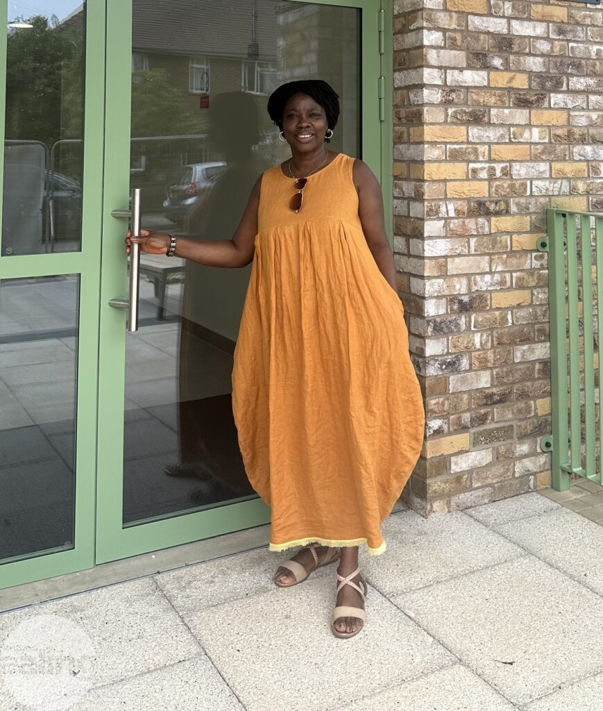 Evelyn standing in front of one of the Northolt Grange buildings