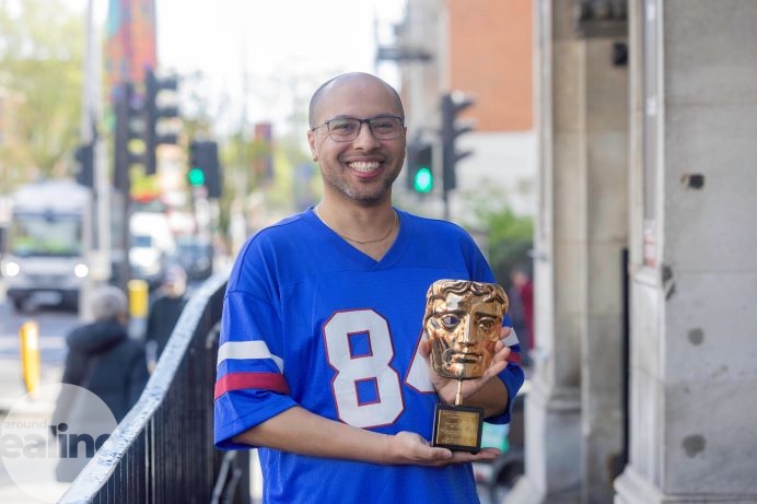 man holding BAFTA award