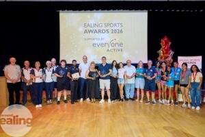 sports awards winners lined up in a hall with their trophies
